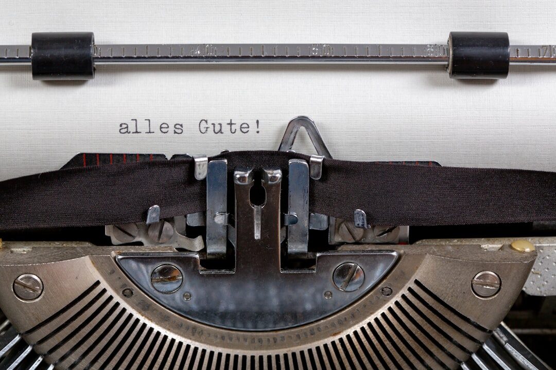 Close-up of vintage typewriter keys with a sheet of paper partially typed