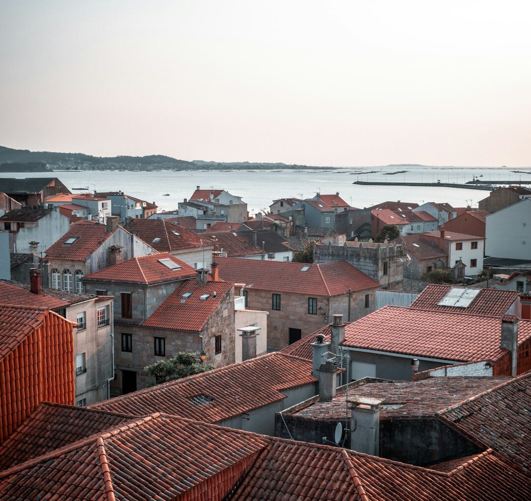 Terracotta rooftops of an old Croatian coastal town at dusk viewed from above