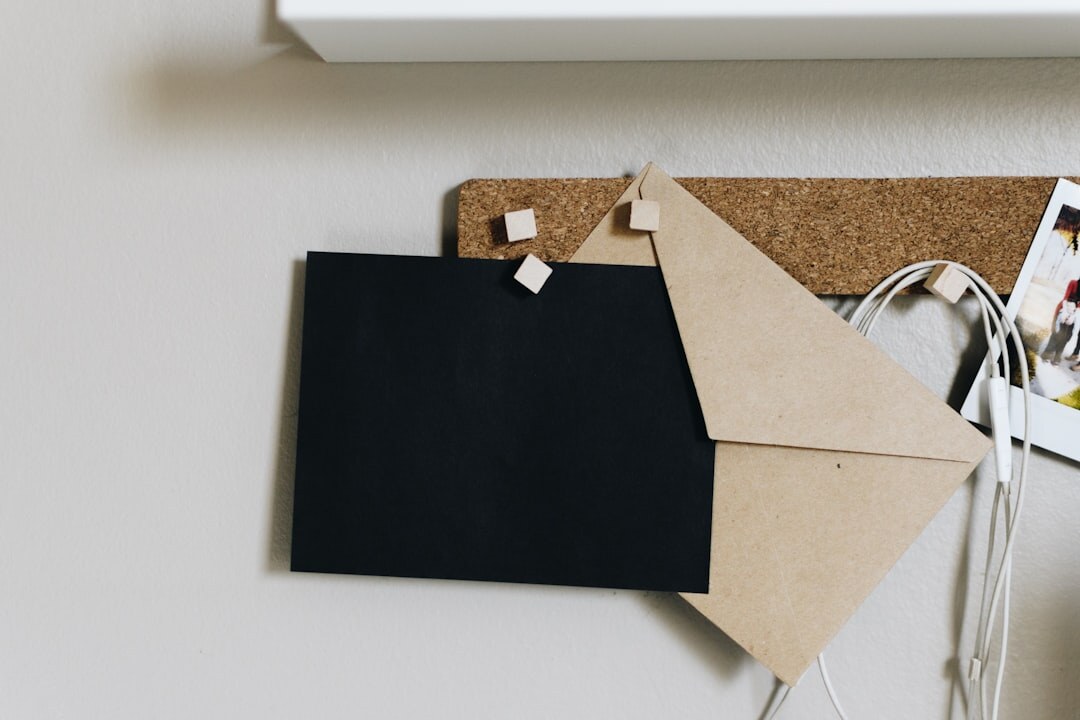 Investigation board with photographs, red string and handwritten notes pinned on cork board
