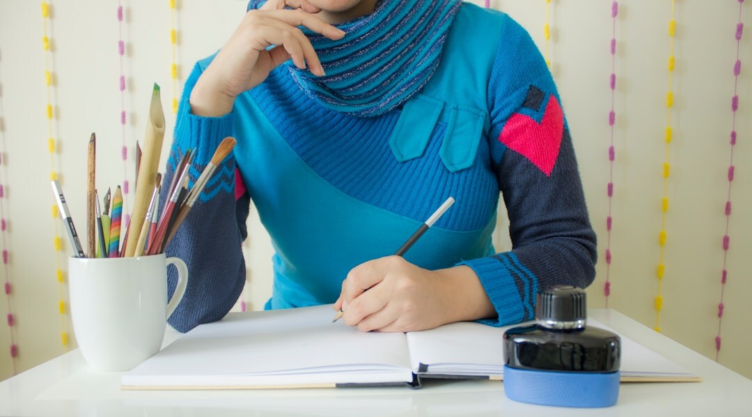 writer at desk with notebook and pen